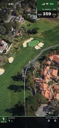 The tracer arcs down over the fairway as the camera follows the ball toward the green.